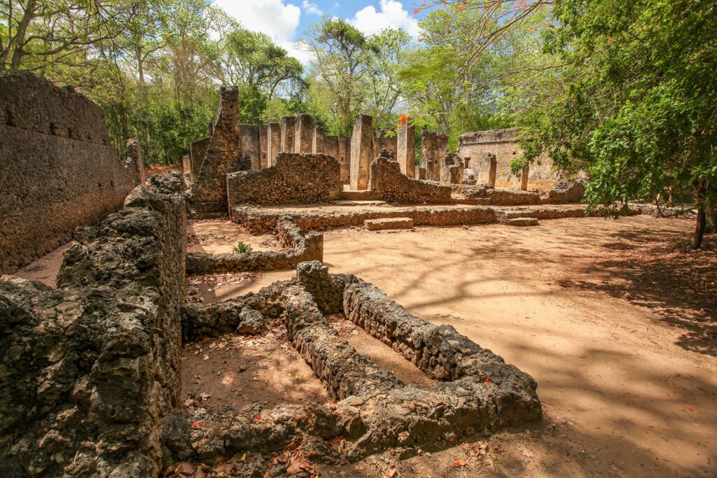 A picture of Gede ruins in kenya with trees and sky background